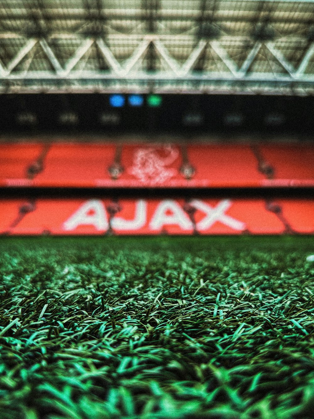 a soccer field with a stadium in the background