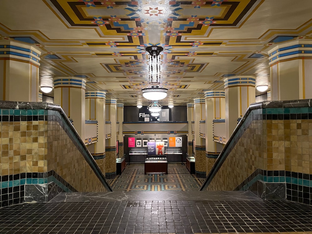 a hallway with a tiled floor and a chandelier