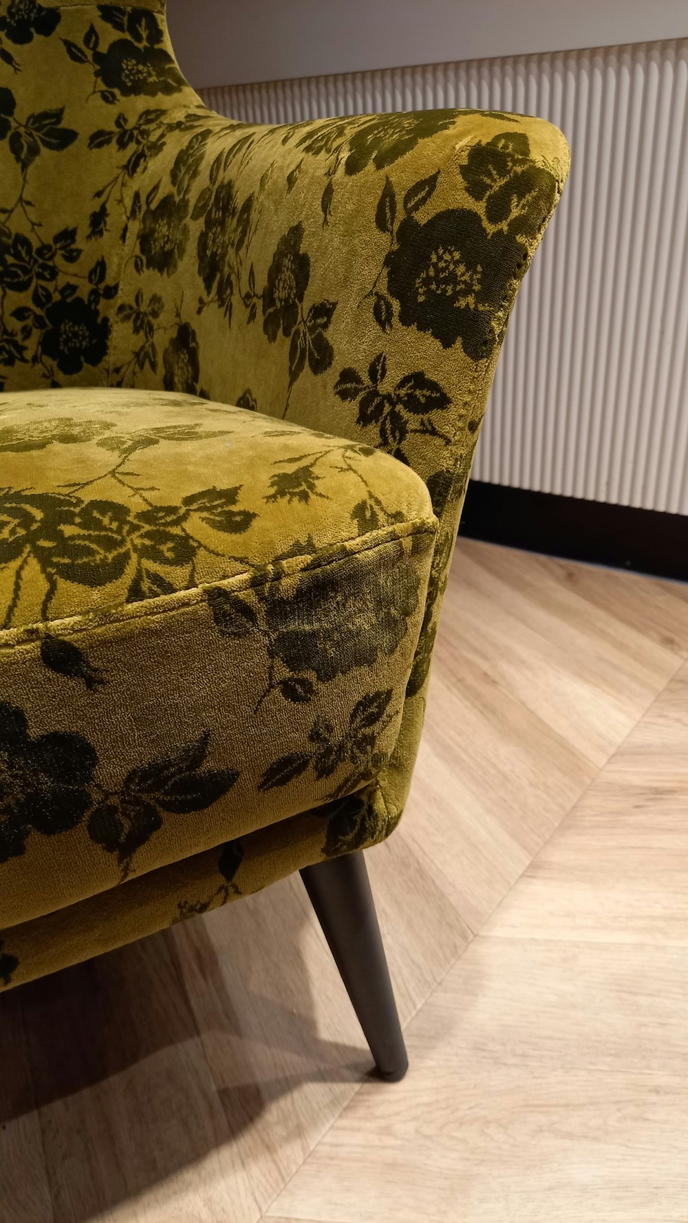 a yellow chair with a floral pattern on it