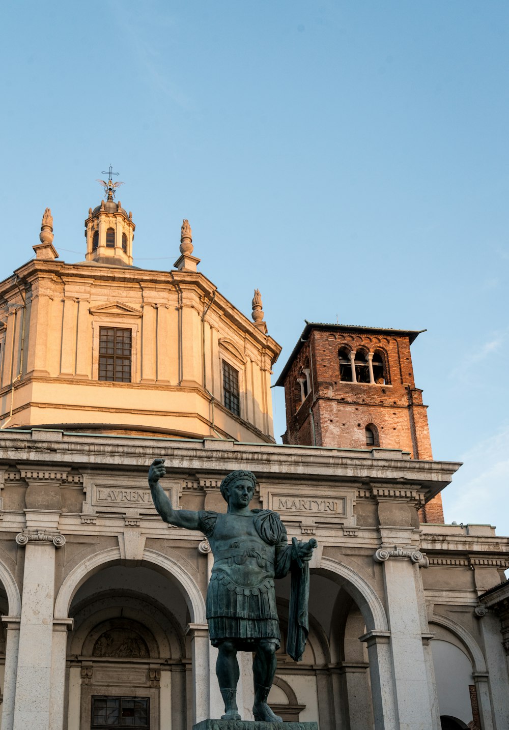 a statue of a roman soldier in front of a building