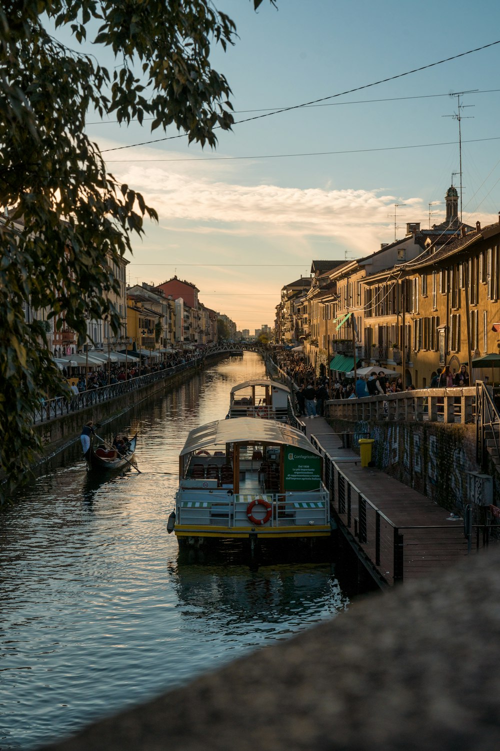 a boat traveling down a river next to tall buildings