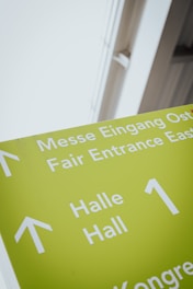 a green sign with white arrows pointing in different directions