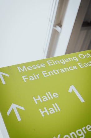 a green sign with white arrows pointing in different directions