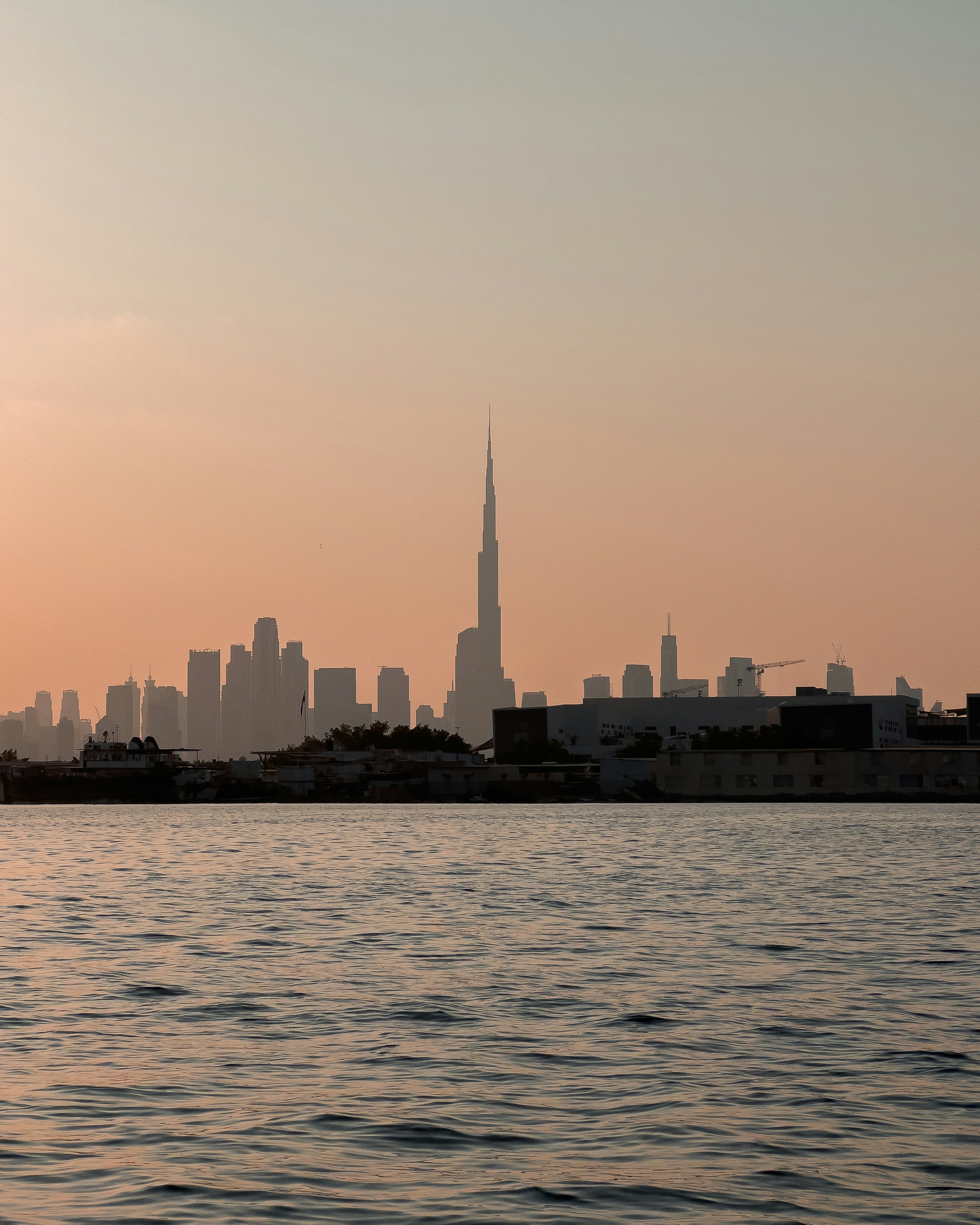 a large body of water with a city in the background