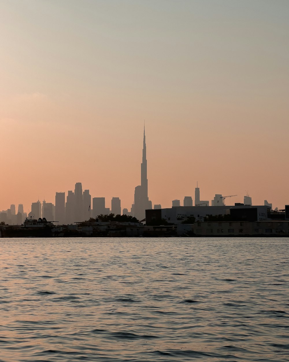 a large body of water with a city in the background