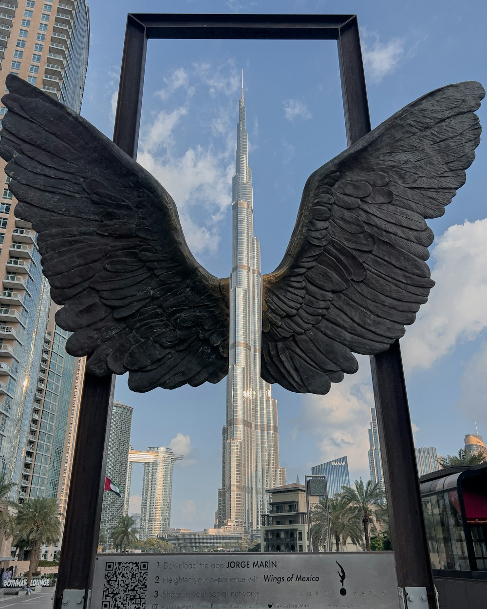 a statue of an angel with a building in the background