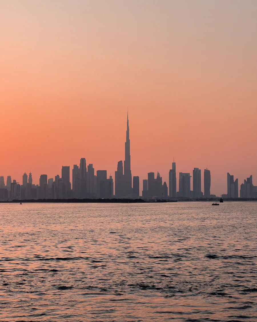 City towers rising beyond a wide stretch of water