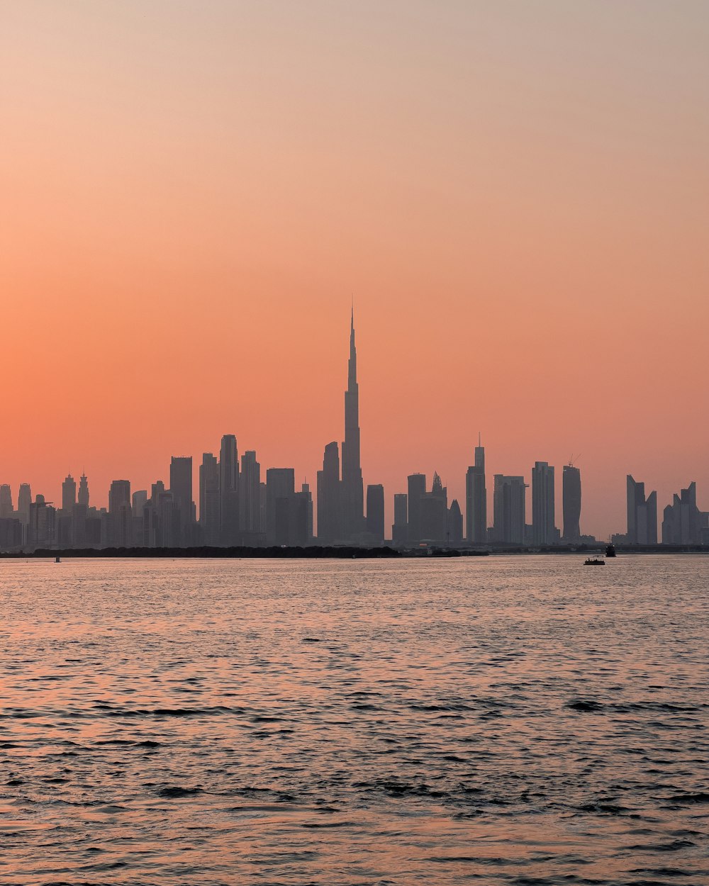 a large body of water with a city in the background