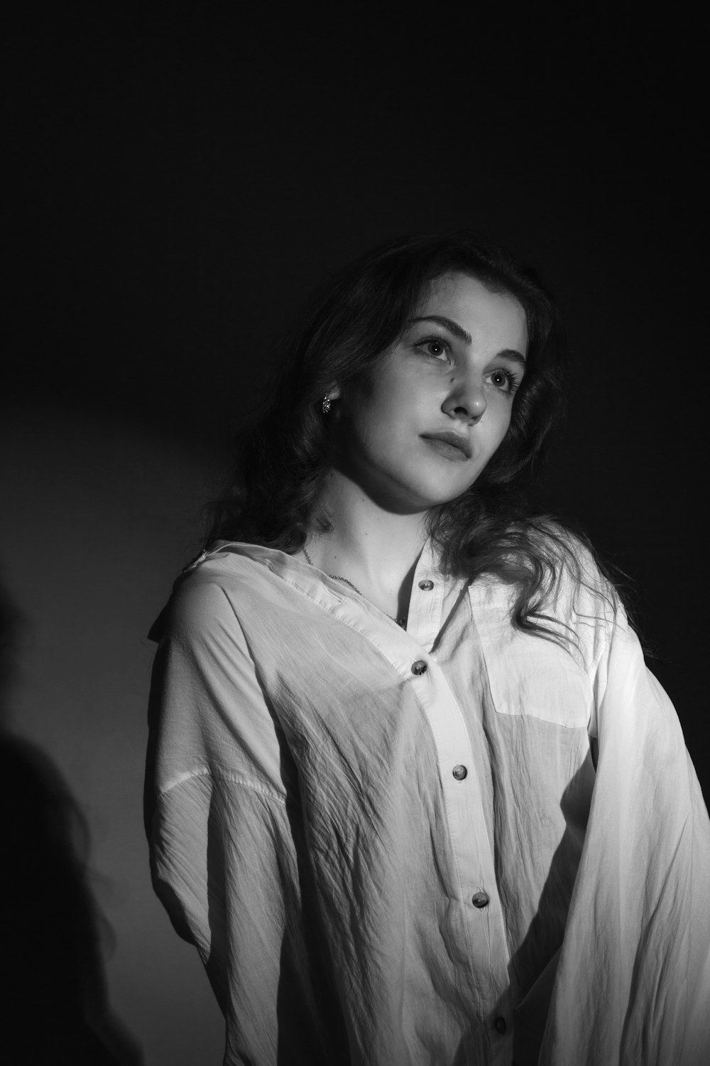 a black and white photo of a woman in a shirt