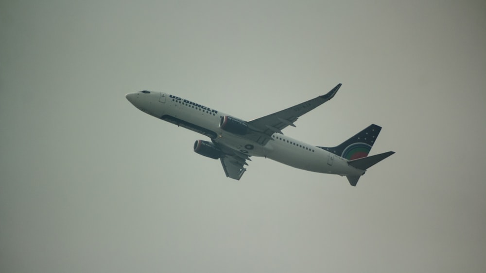 a large jetliner flying through a cloudy sky