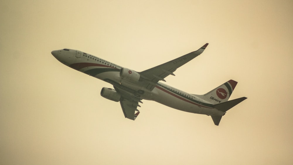 a large jetliner flying through a cloudy sky