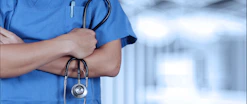 a person in scrubs with a stethoscope on their arm