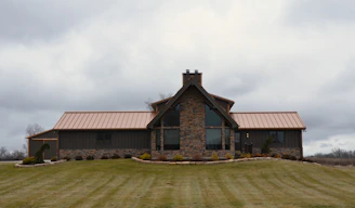 a house with a metal roof on a cloudy day