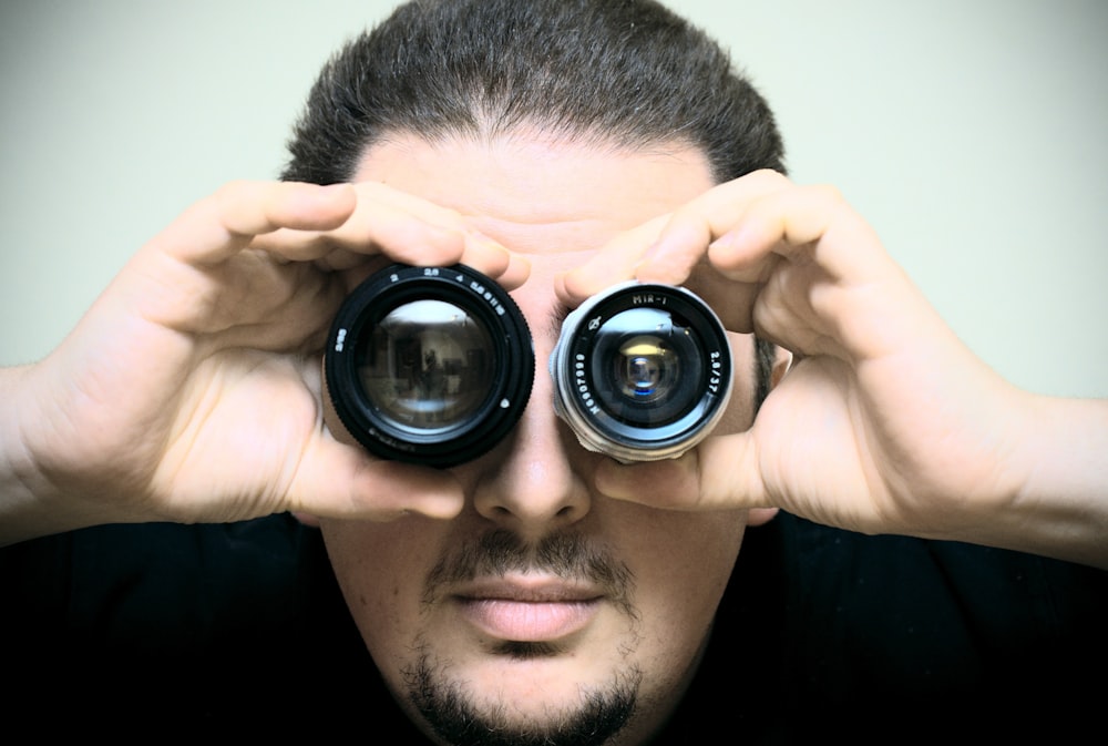 a man looking through a pair of binoculars