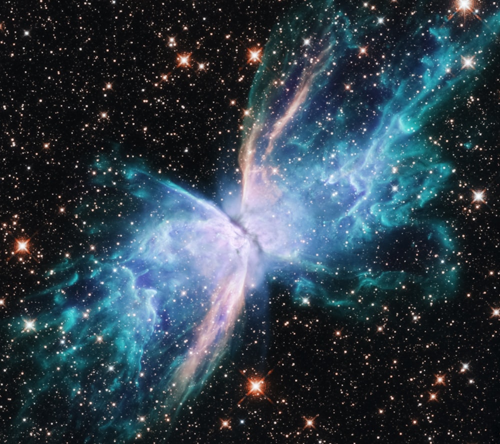 a butterfly shaped object in the middle of a star filled sky