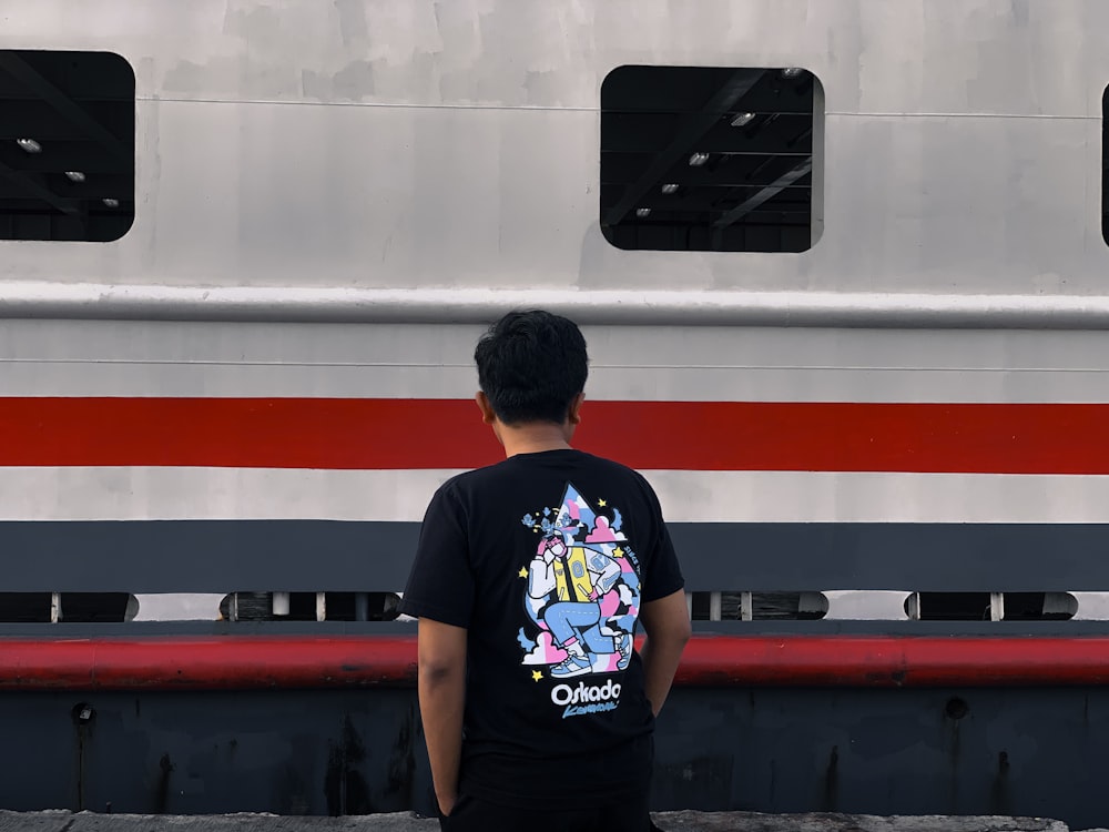 a man standing in front of a train