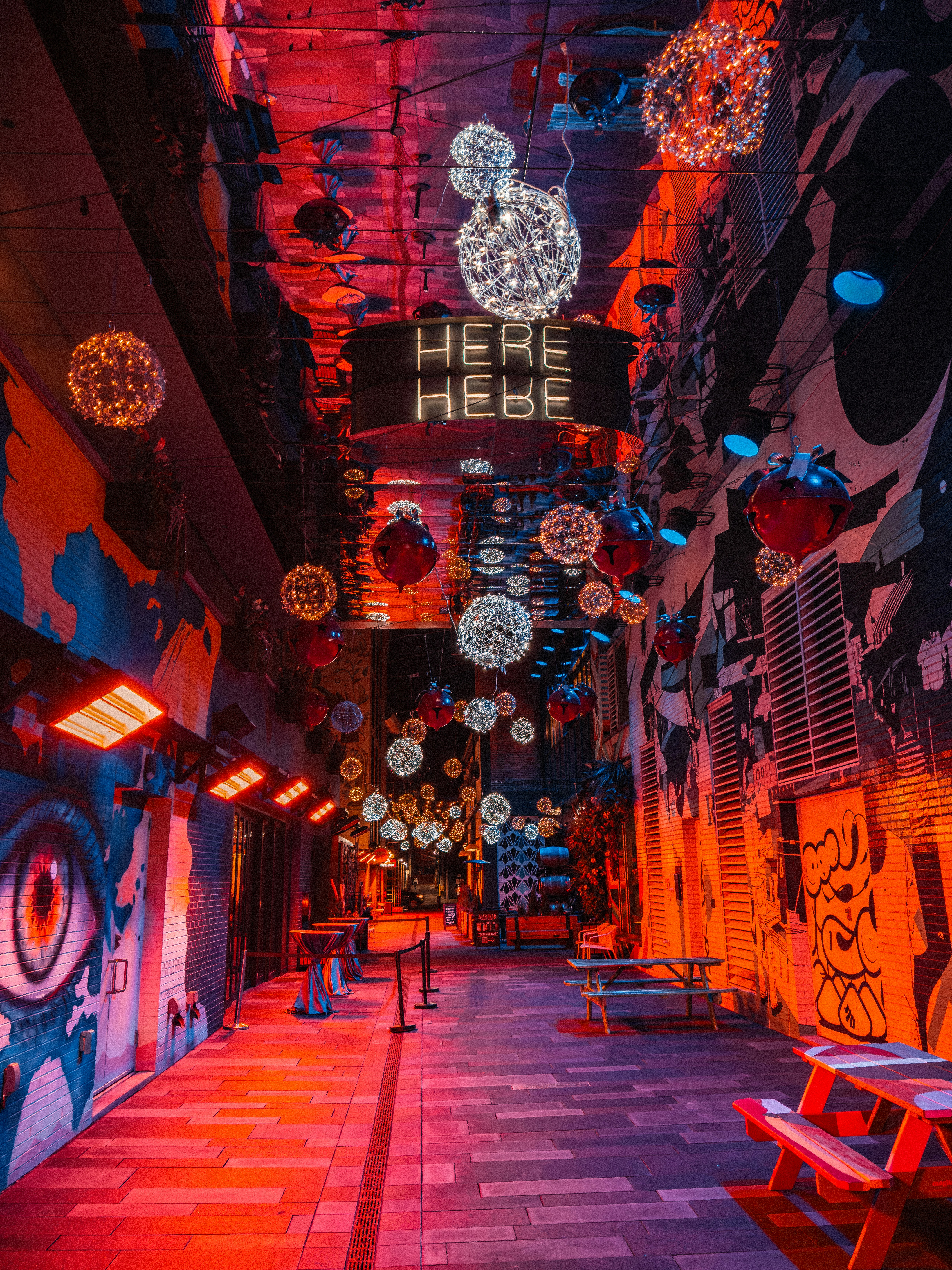 a brightly lit hallway with a sign that says here