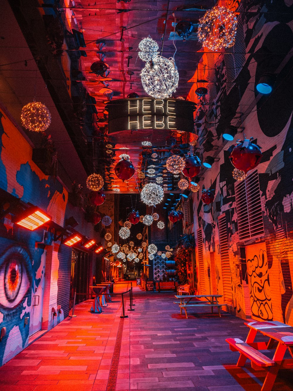 a brightly lit hallway with a sign that says here