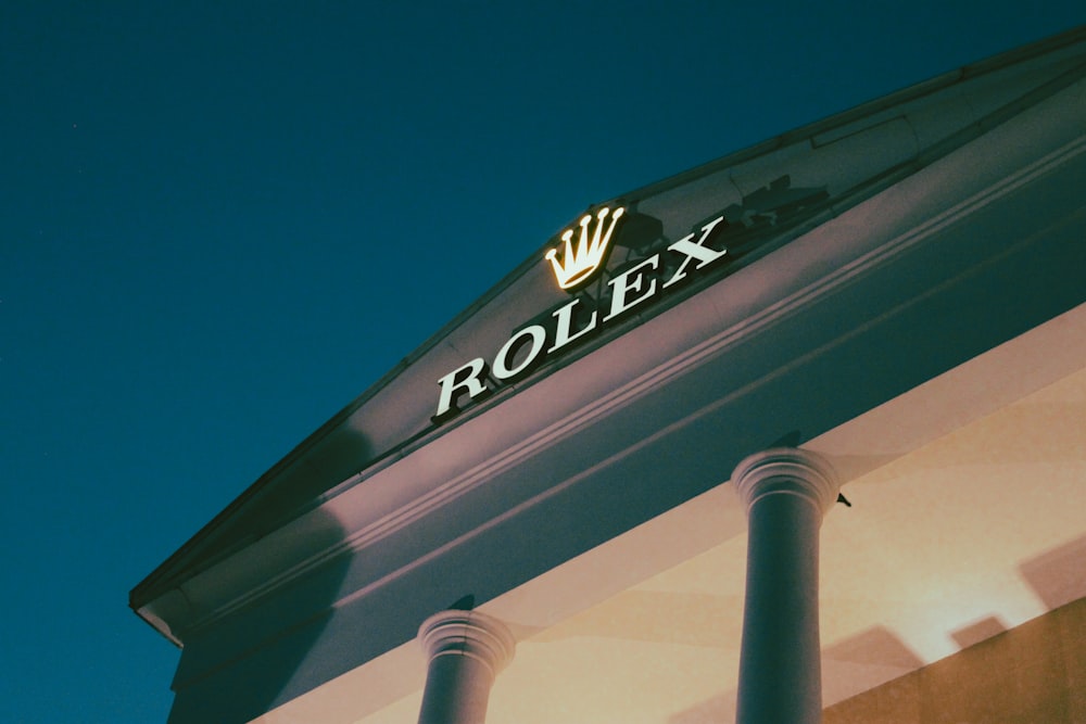 a rolex store sign on the side of a building