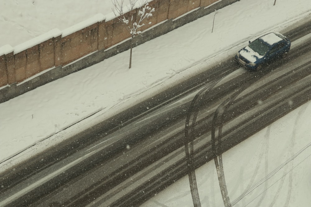 a car driving down a snow covered road