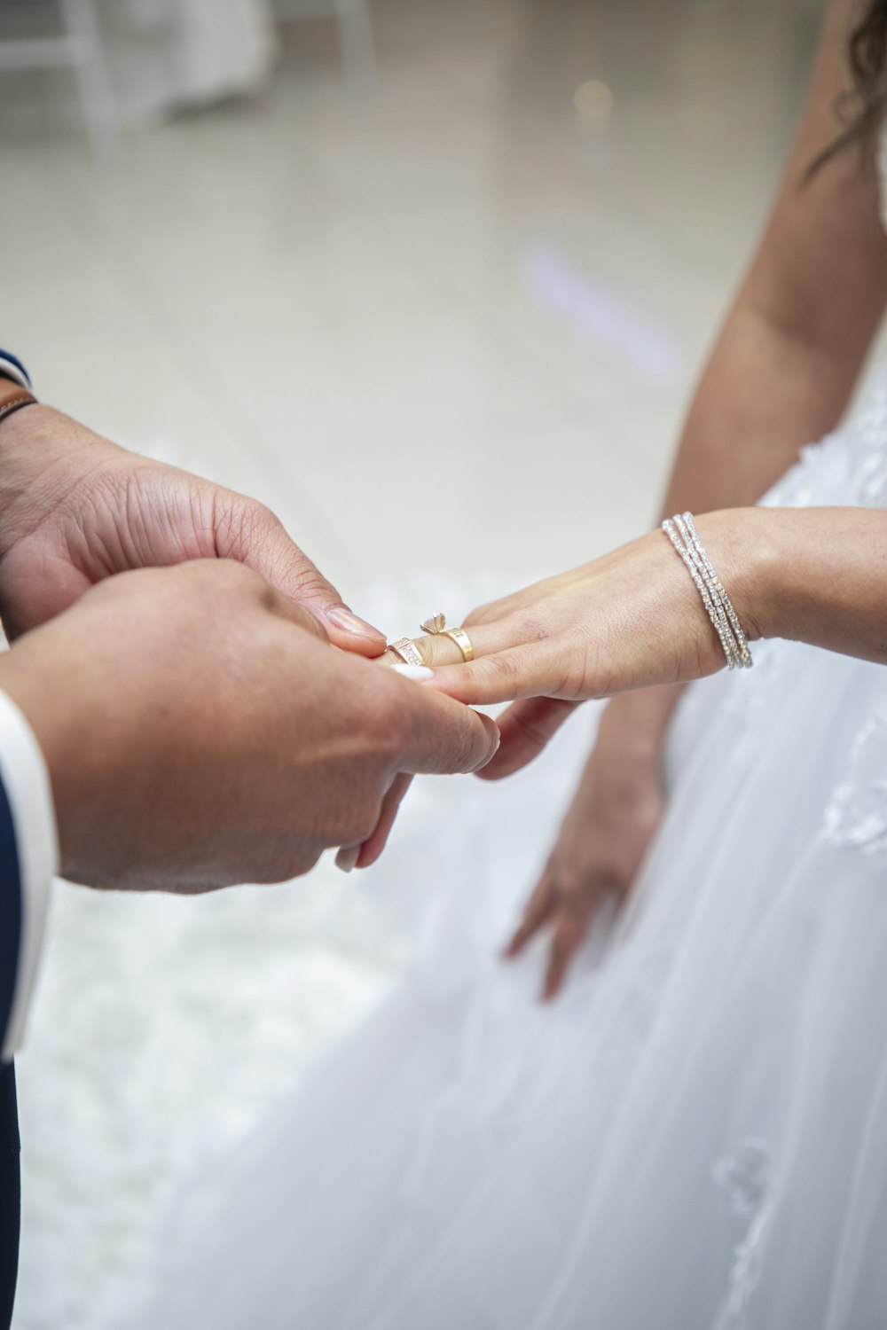 a bride and groom holding hands during a wedding ceremony