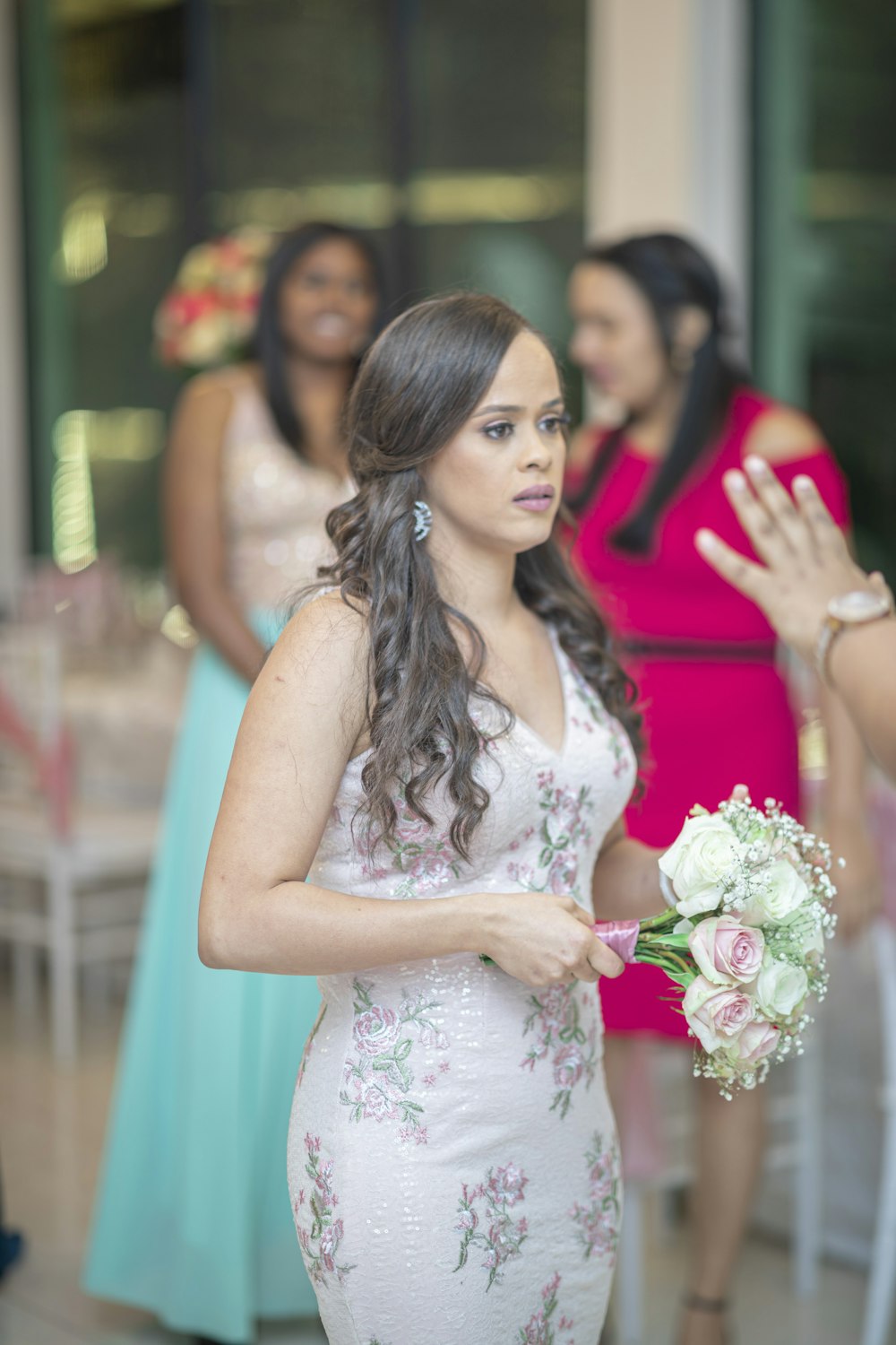 a woman in a white dress holding a bouquet of flowers