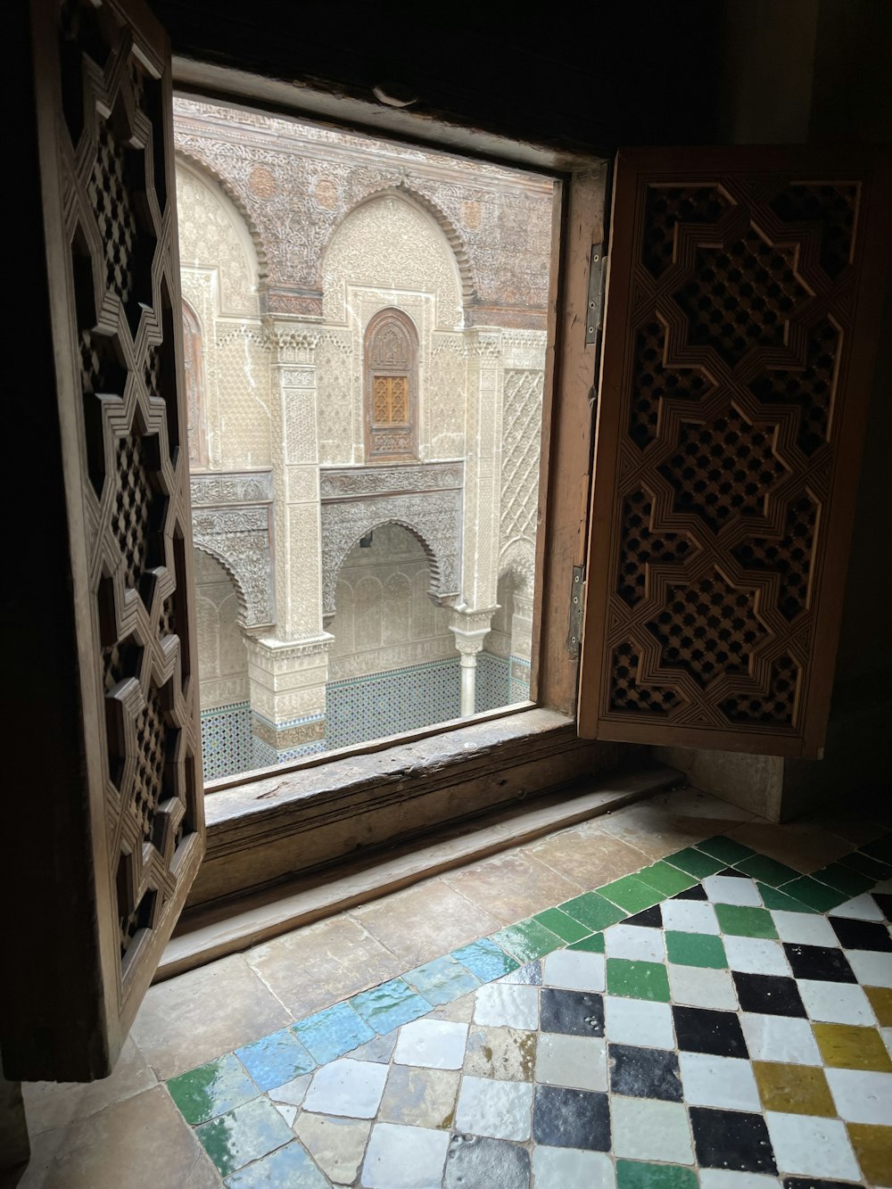 an open window with a tiled floor and walls