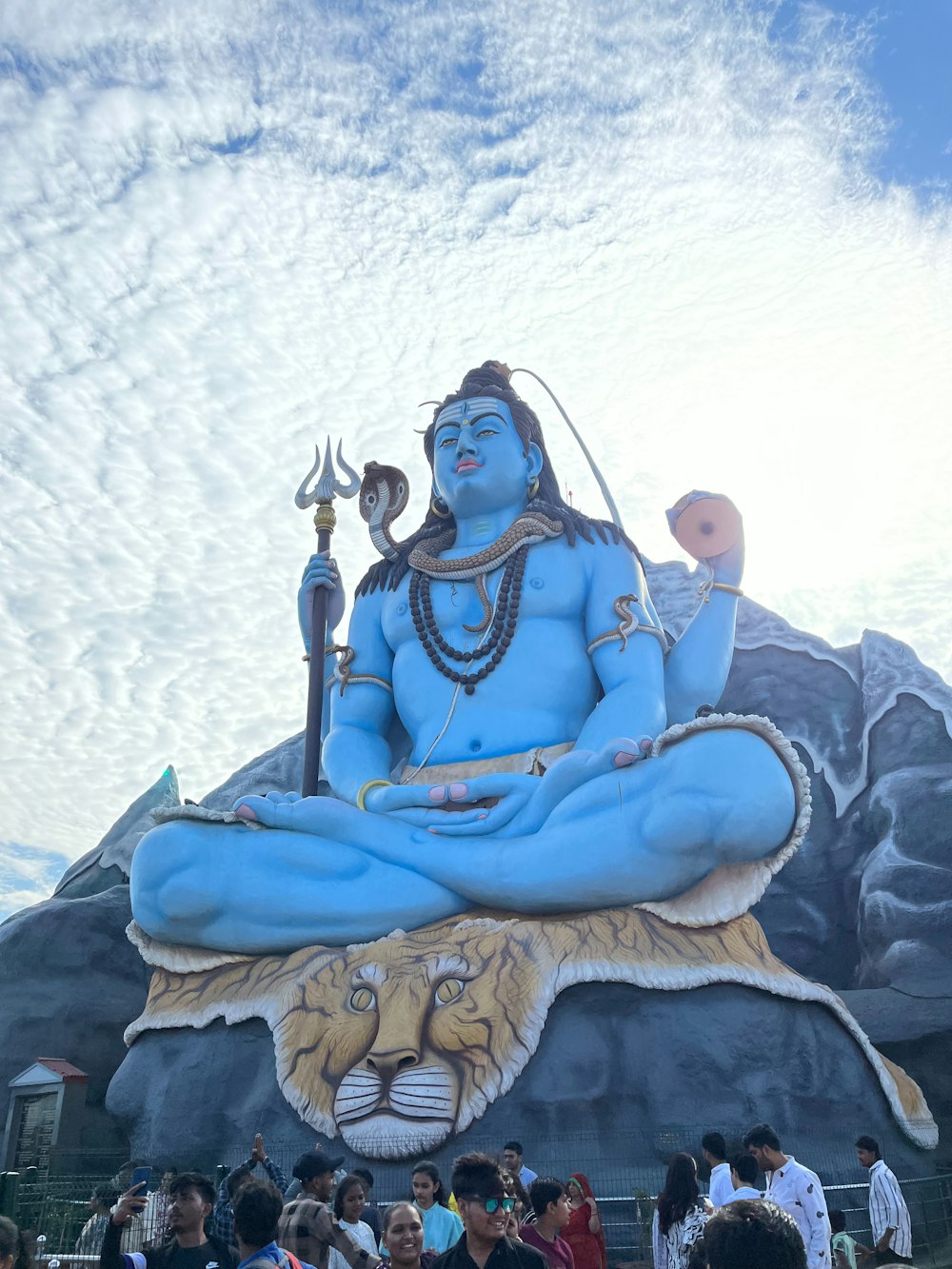 a large statue of a man sitting on top of a tiger