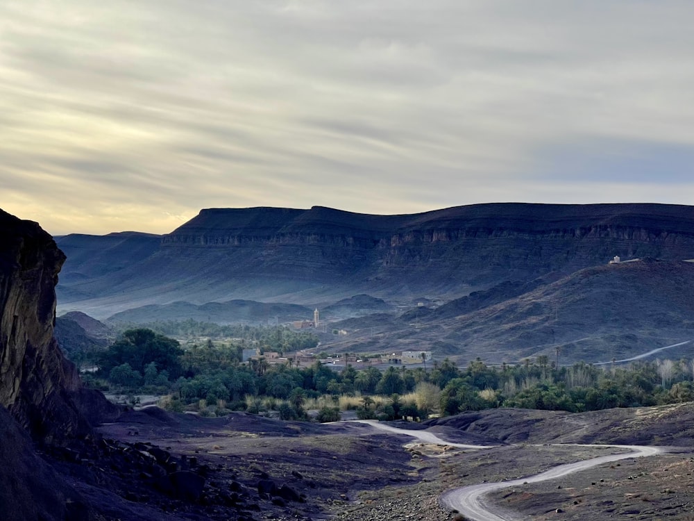 a scenic view of a winding road in the mountains