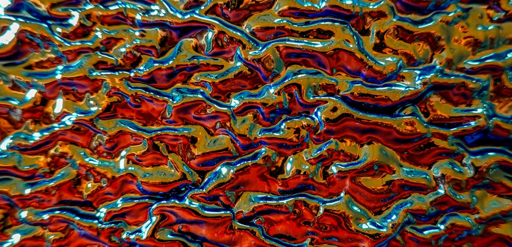 a close up view of a red, blue, and yellow glass surface