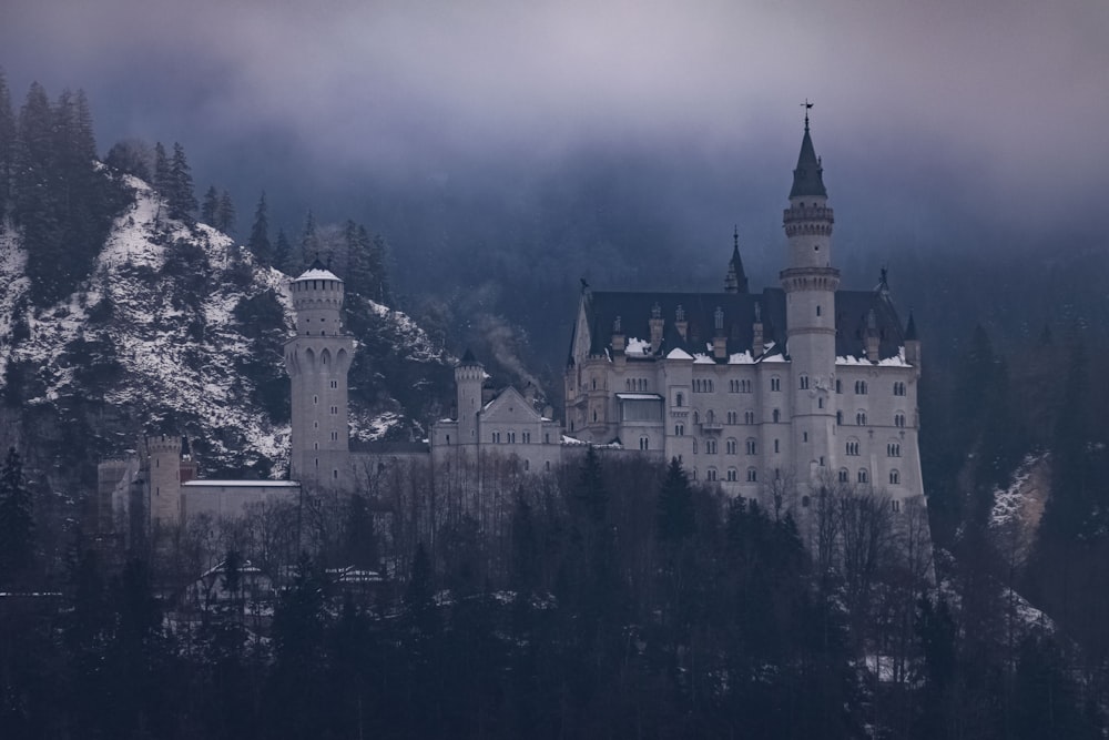 a castle on top of a mountain covered in snow