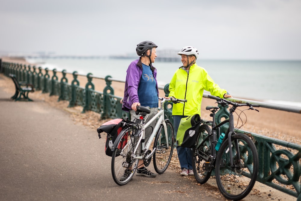 a couple of people that are standing next to some bikes