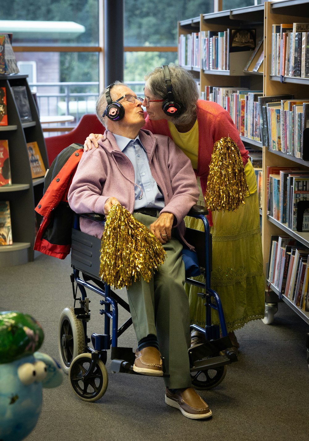 a woman kissing a man in a wheel chair