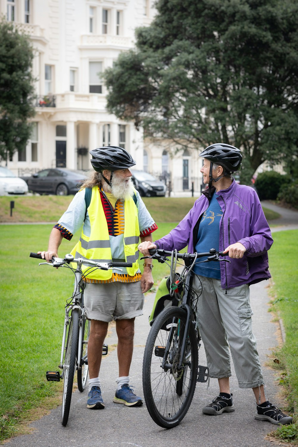 a couple of men standing next to each other near a bike