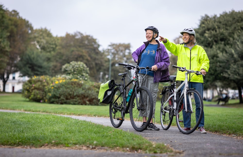 a man and a woman standing next to their bikes