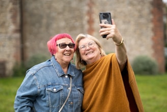 two women taking a picture with a cell phone