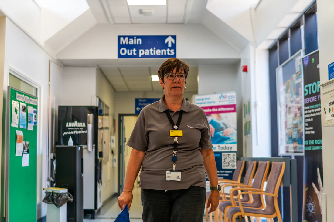 NHS staff member in a hospital corridor