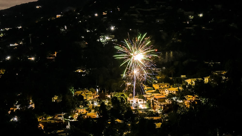 a fireworks display in the night sky over a city