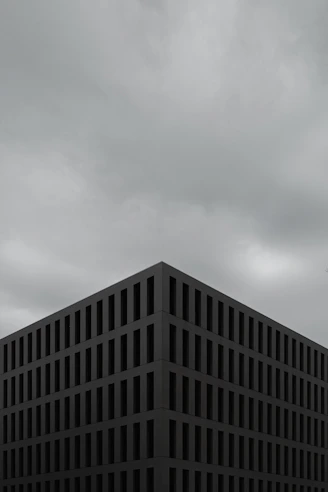 a tall building sitting under a cloudy sky