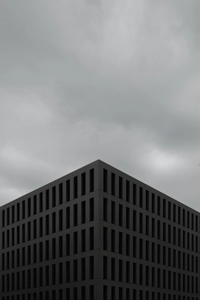 a tall building sitting under a cloudy sky