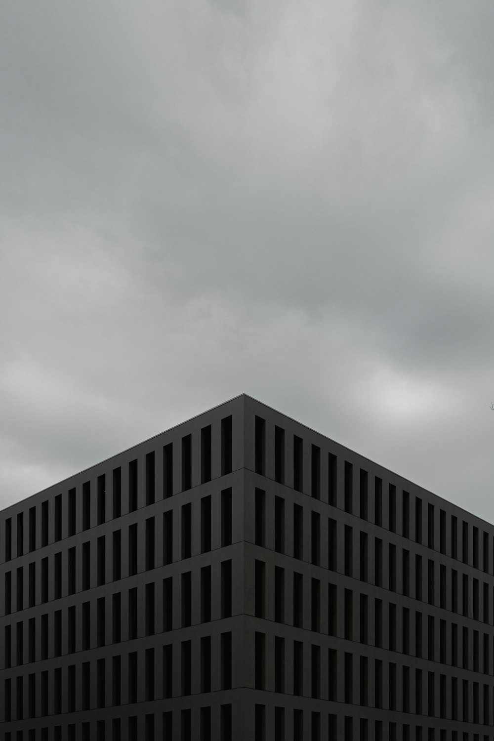 a tall building sitting under a cloudy sky