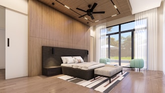 a bedroom with a bed and a ceiling fan