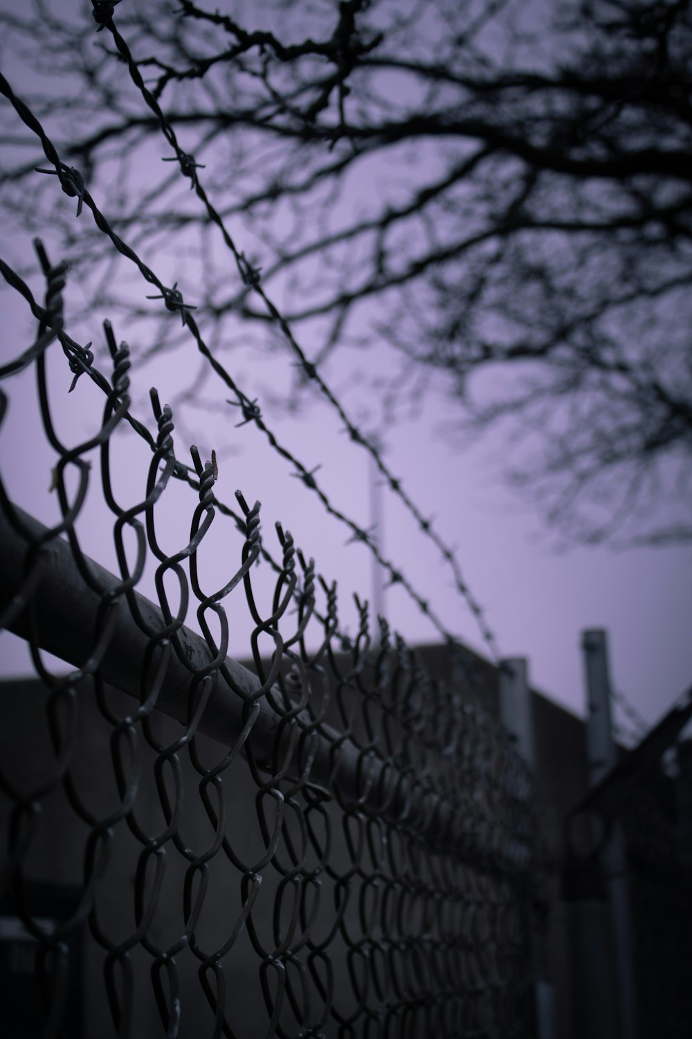 a chain link fence with a building in the background