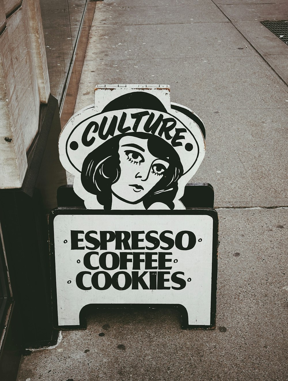 a sign on the side of a building that says culture espresso coffee cookies