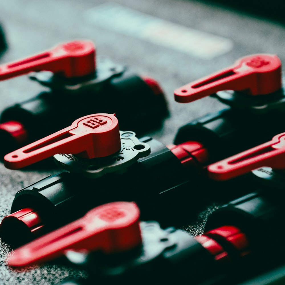 a close up of a bunch of red and black valves