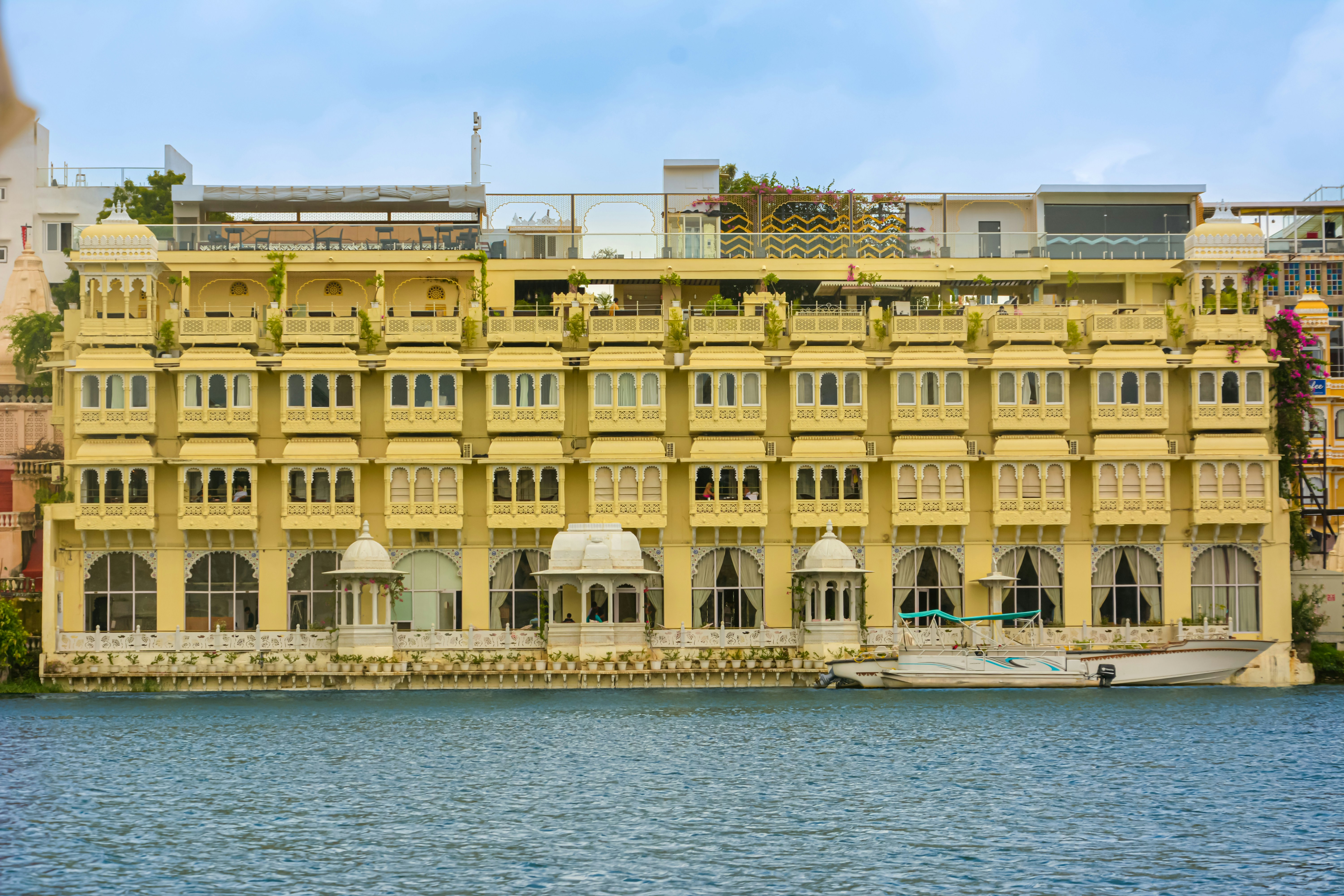 a large yellow building sitting next to a body of water