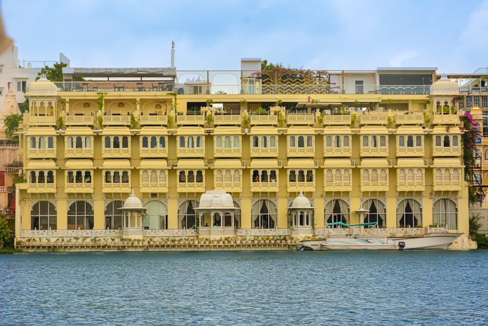 a large yellow building sitting next to a body of water