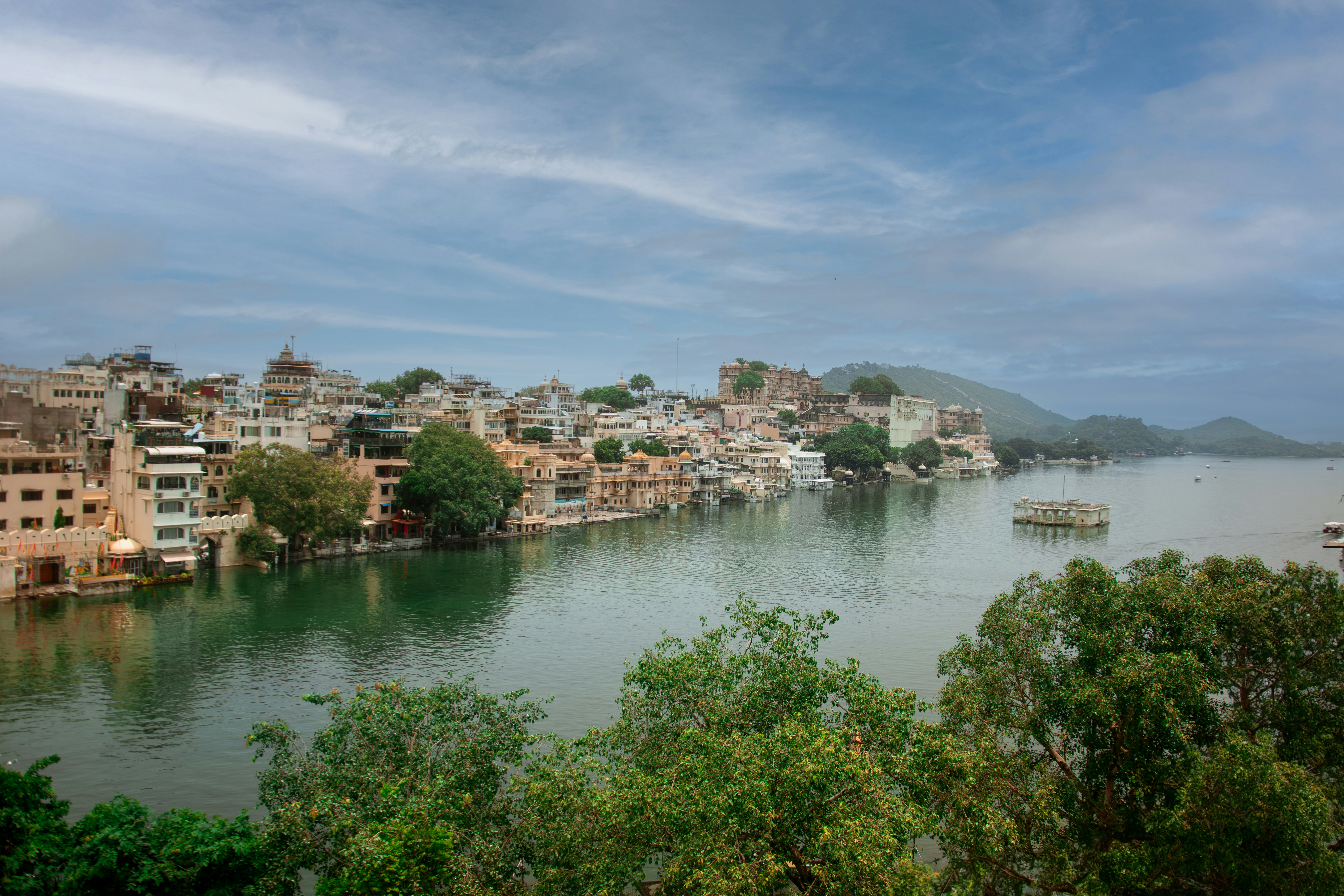 a body of water surrounded by trees and buildings