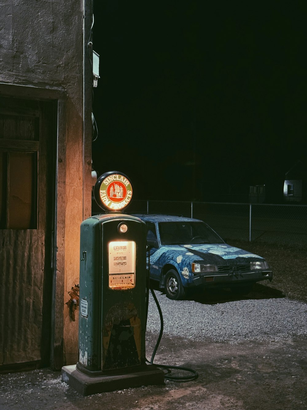 an old gas pump sitting in front of a building