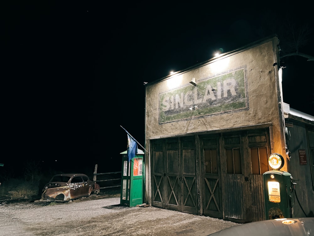 a car parked in front of a building at night